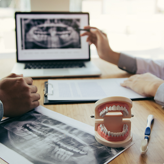Orthodontist showing a patient an x-ray of their teeth