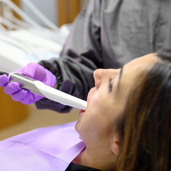 Woman getting digital impressions of her teeth taken