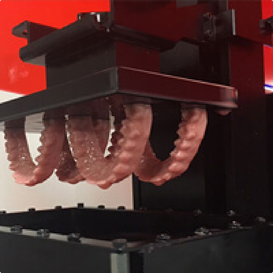 3D printer creating four models of the teeth