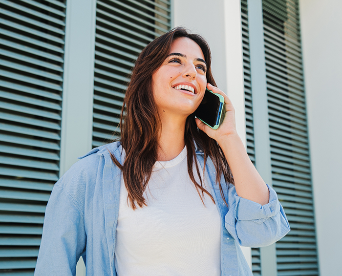 Woman smiling while talking on the phone
