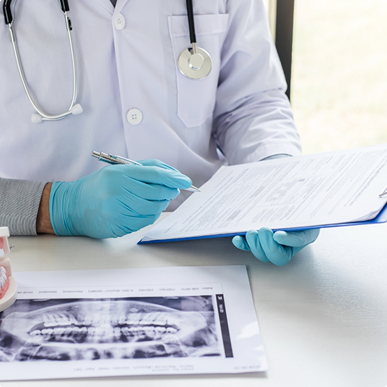 Orthodontist looking through a patient's paperwork