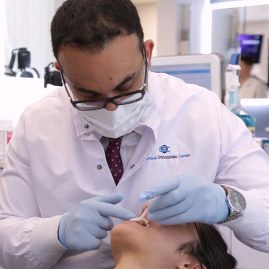 Orthodontist examining a patient's teeth