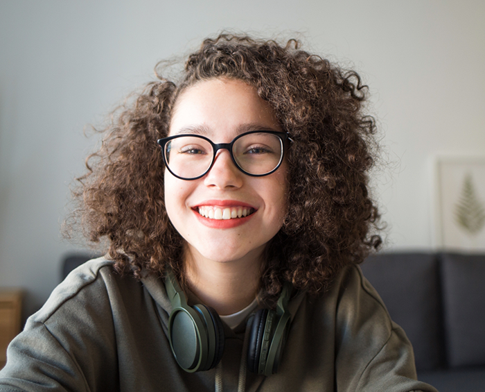 Young woman grinning after treatment with Invisalign Teen in Columbus