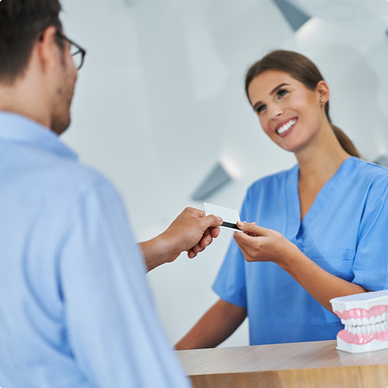 Man paying for orthodontic treatment