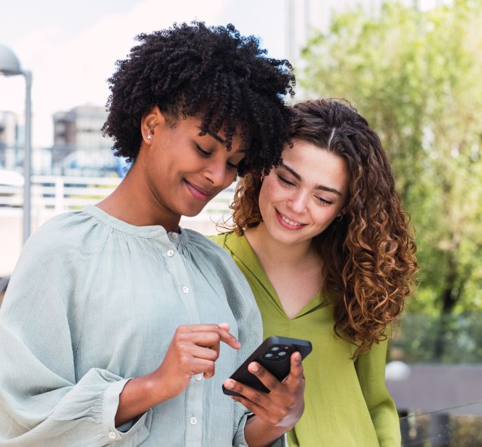 Two women looking at a phone