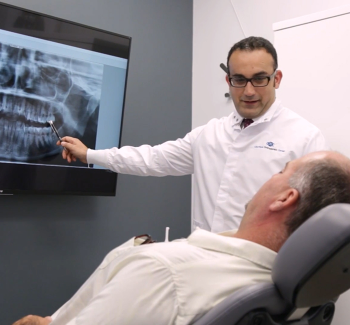 Doctor Mason showing a patient an x-ray of his teeth