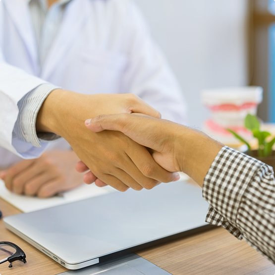 Person shaking hands with their orthodontist