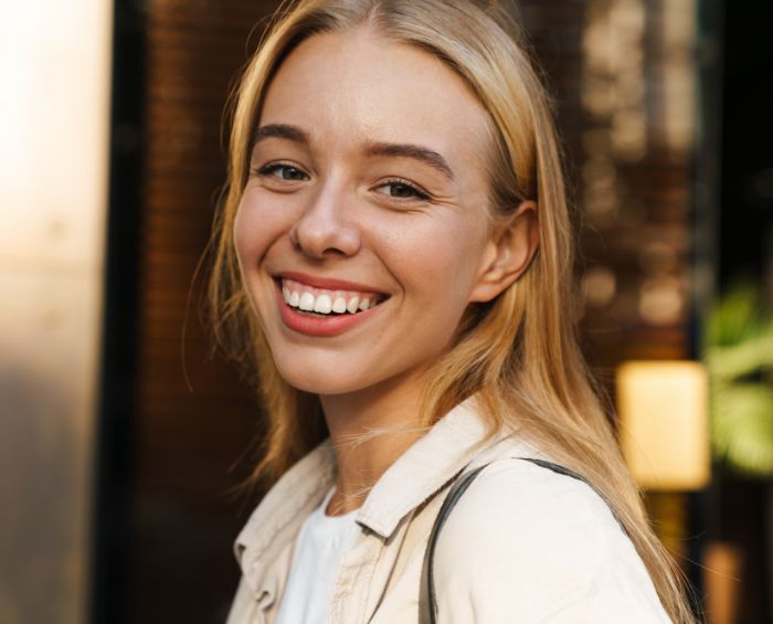 Smiling blonde woman with straight teeth