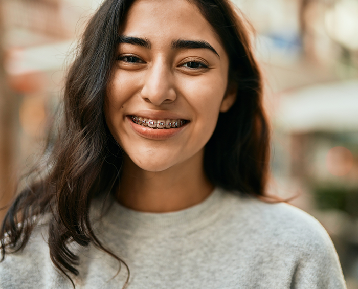 Smiling teenage girl with traditional braces