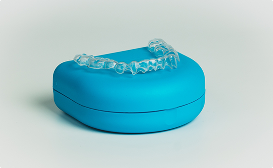 Invisalign resting on top of its storage case