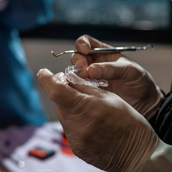 Dental professional holding Invisalign