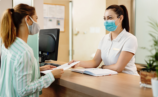 Woman paying for her dental treatment