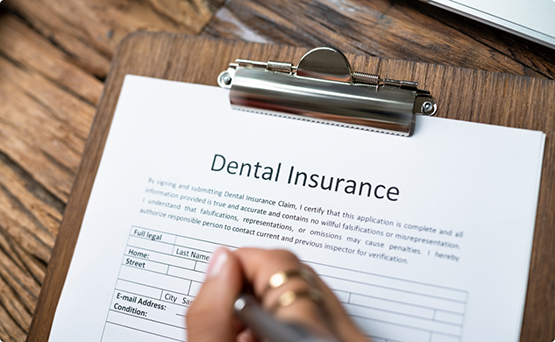 Person filling out a dental insurance form