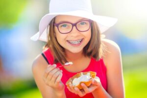 Preteen girl with braces enjoying ice cream